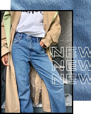 A woman wearing a trench coat and loose Levi jeans