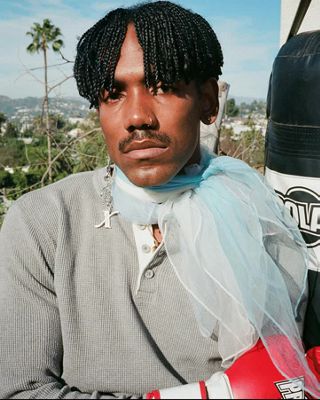 GIFs of Jerrod La Rue standing on a balcony.