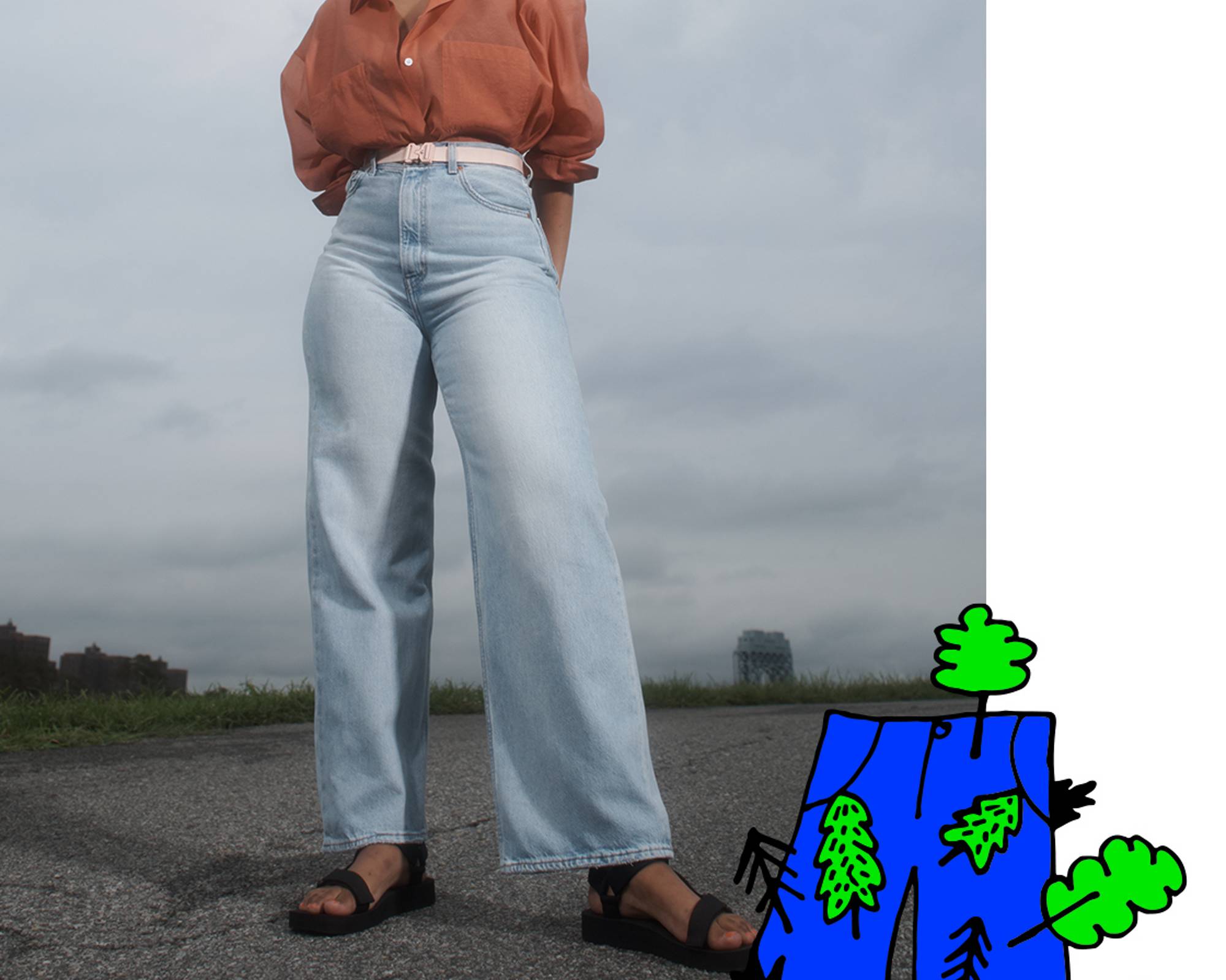 a model wearing high loose jeans with a graphic of jeans and trees over it