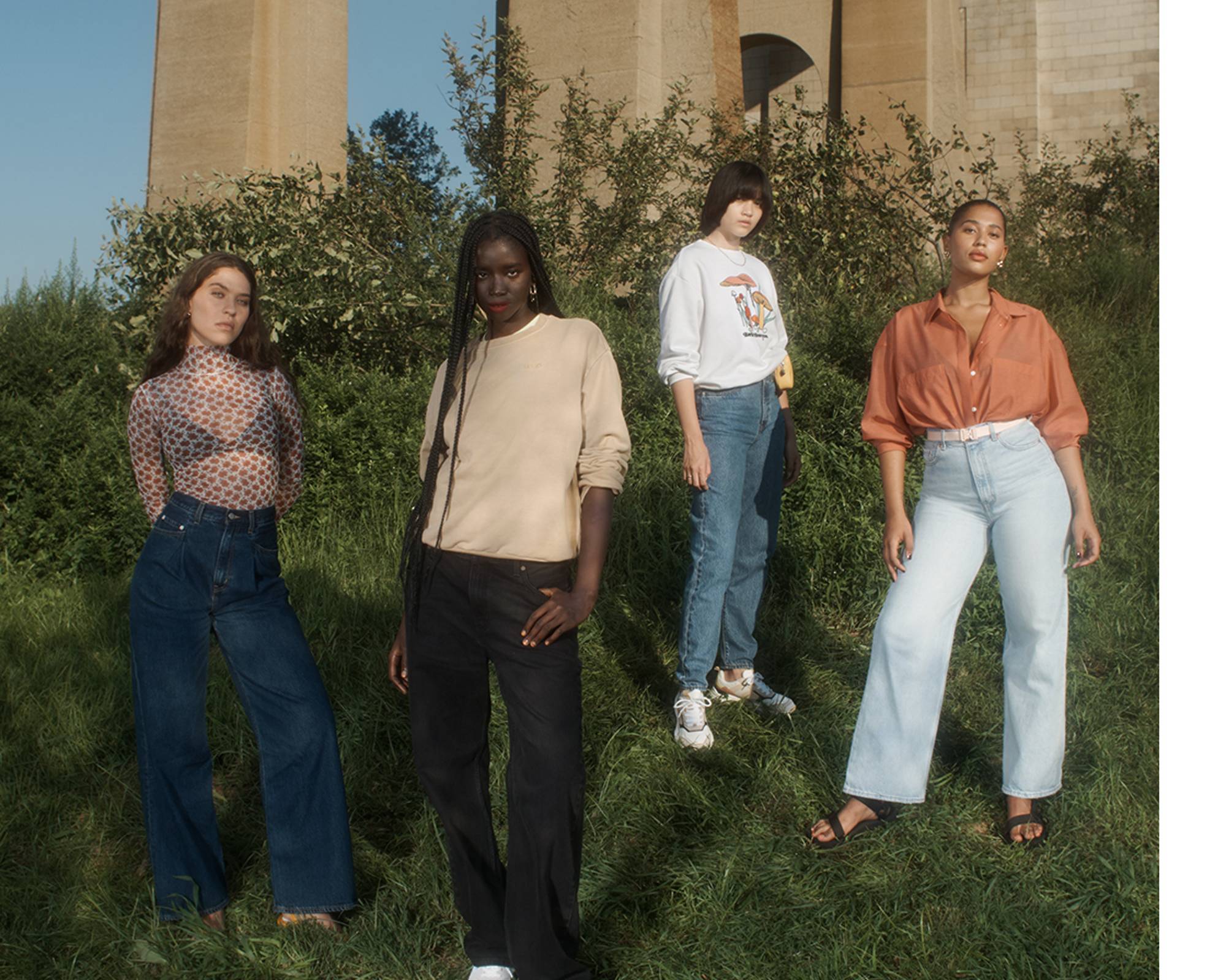 Models wearing the Loose Straight and High Loose jeans standing in a field
