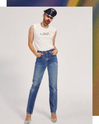 Brendan wearing jeans, heels and a white tshirt