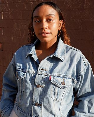 Portrait of Evelynn Escobar-Thomas wearing a Levi's Trucker Jacket.