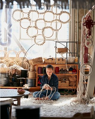 Photo of Windy Chien working on a fiber sculpture in her studio.