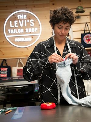 Emily Carrig pinning pant legs to hem them