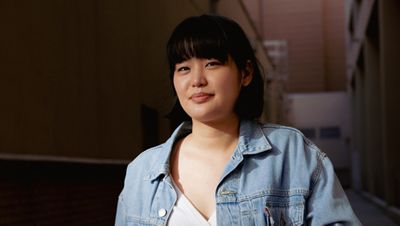 Lisa Hon standing wearing Levi's jacket