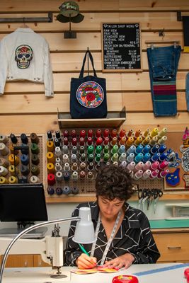 Emily Carrig sitting at her sewing machine