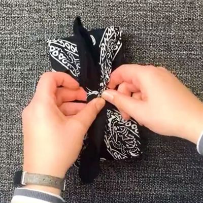 tying bow on bandana gift wrap