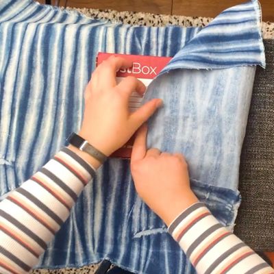 hand wrapping denim fabric over gift