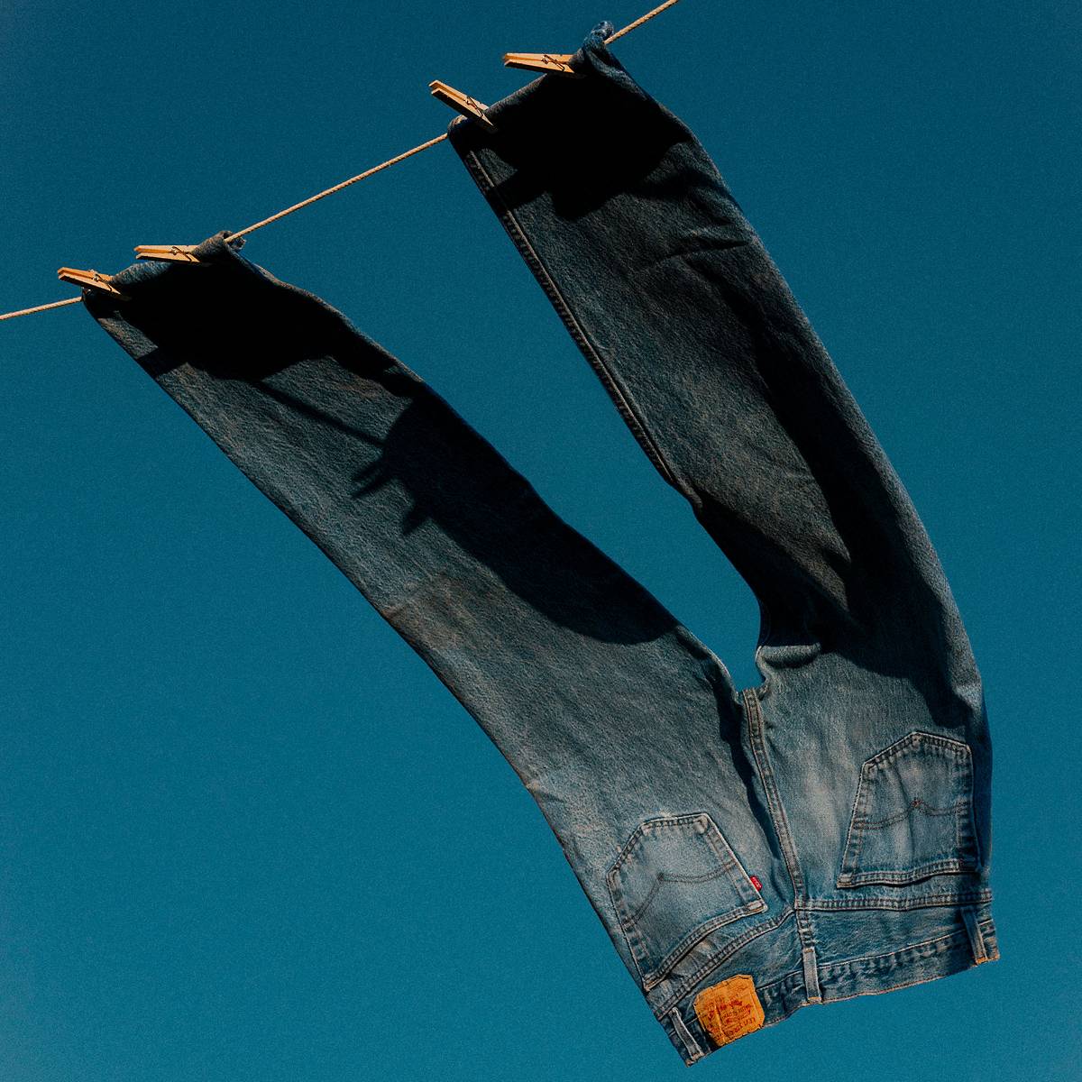 Dark wash jeans hung up to line dry