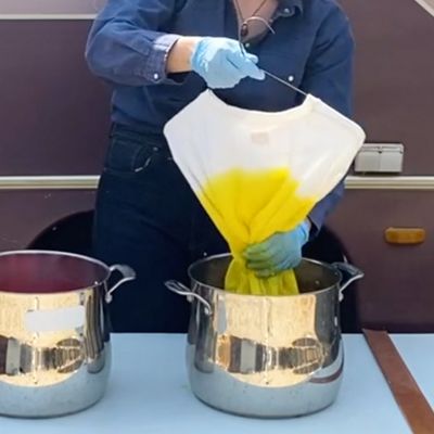 dipping garment into pot