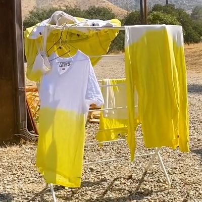 pigment dyed garments hanging on clothing rack outside