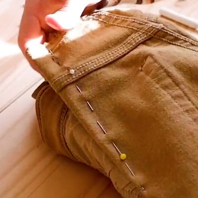 pins down leg of brown jeans