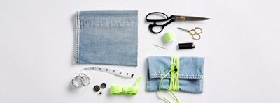 Image of things needed to complete the DIY, including: a pair of old jeans, flat elastic cord, measuring tape, scissors, a button, sewing needle, sewing pins, thread, and lighter.