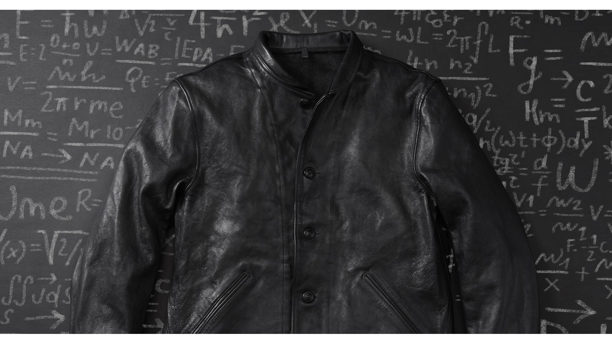 Einstein's original Levi's® Menlo Cossack leather jacket laid on top of a chalkboard background with numbers and equations.