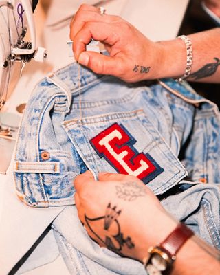 A photo of Emma, a wall of thread, and emma holding up jeans with different colored buttons against them