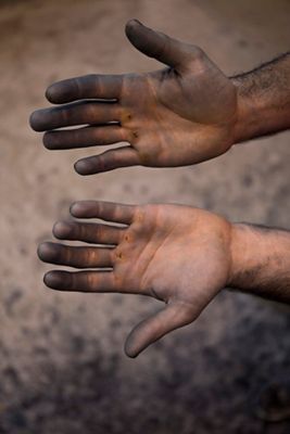 Image of pair of hands covered in dirt.