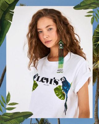 A gif of three images. 1. Woman wearing Levi's t-shirt and jeans featuring jungle animals and plants. 2. A woman wearing Levi's white t-shirt with a blue parrot on it. 3. Close up photo of the Levi Strauss & Co. Patch on the back pocket of a pair of Levi jeans.
