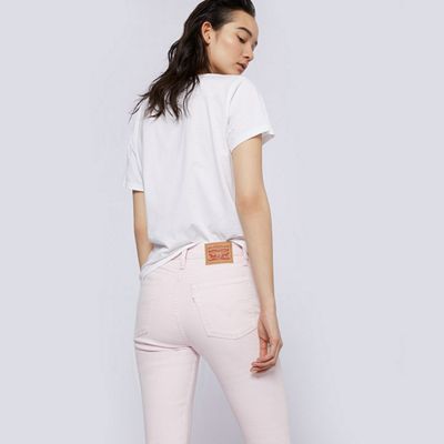 White shirt/ white jeans person facing backwards on a white background