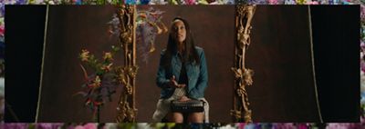 Image of Haben Girma speaking to a camera while surrounded by a golden frame and flowers.