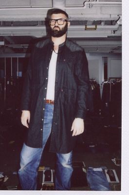 Polaroid photo of Michael Burch inside the Levi's Plaza. He's wearing an open dark indigo top over a white tee with Levi's blue jeans.