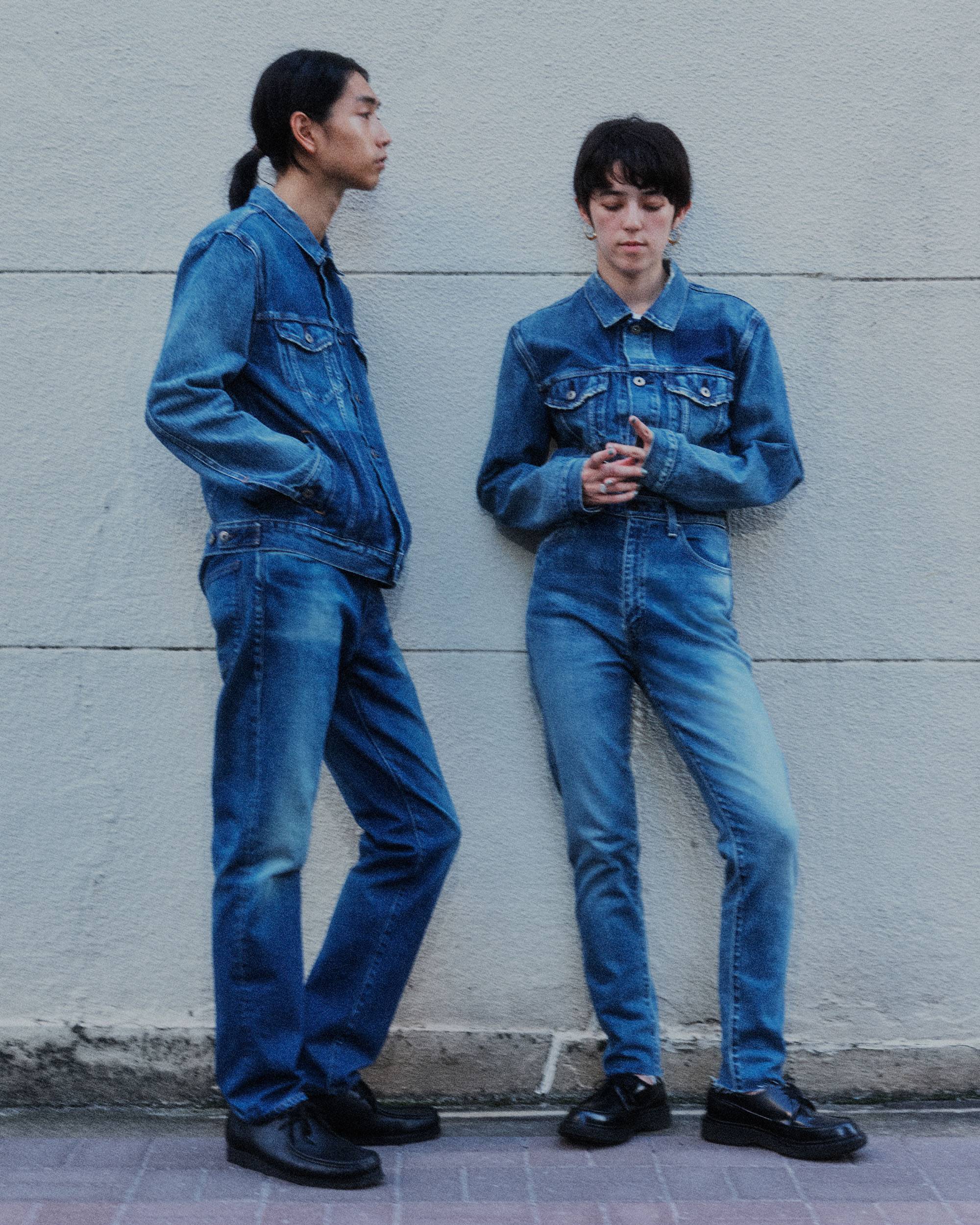 Man and woman in standing denim jacket and jeans.