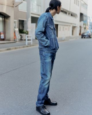 split screen man standing on the street / man standing against a wall