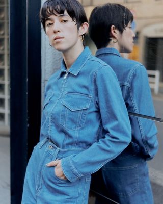 woman standing on street in denim outfit