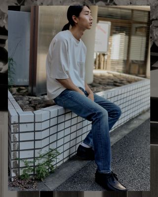 man standing on street in tshirt and jeans