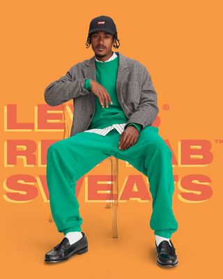 Man in green sweat suit sitting