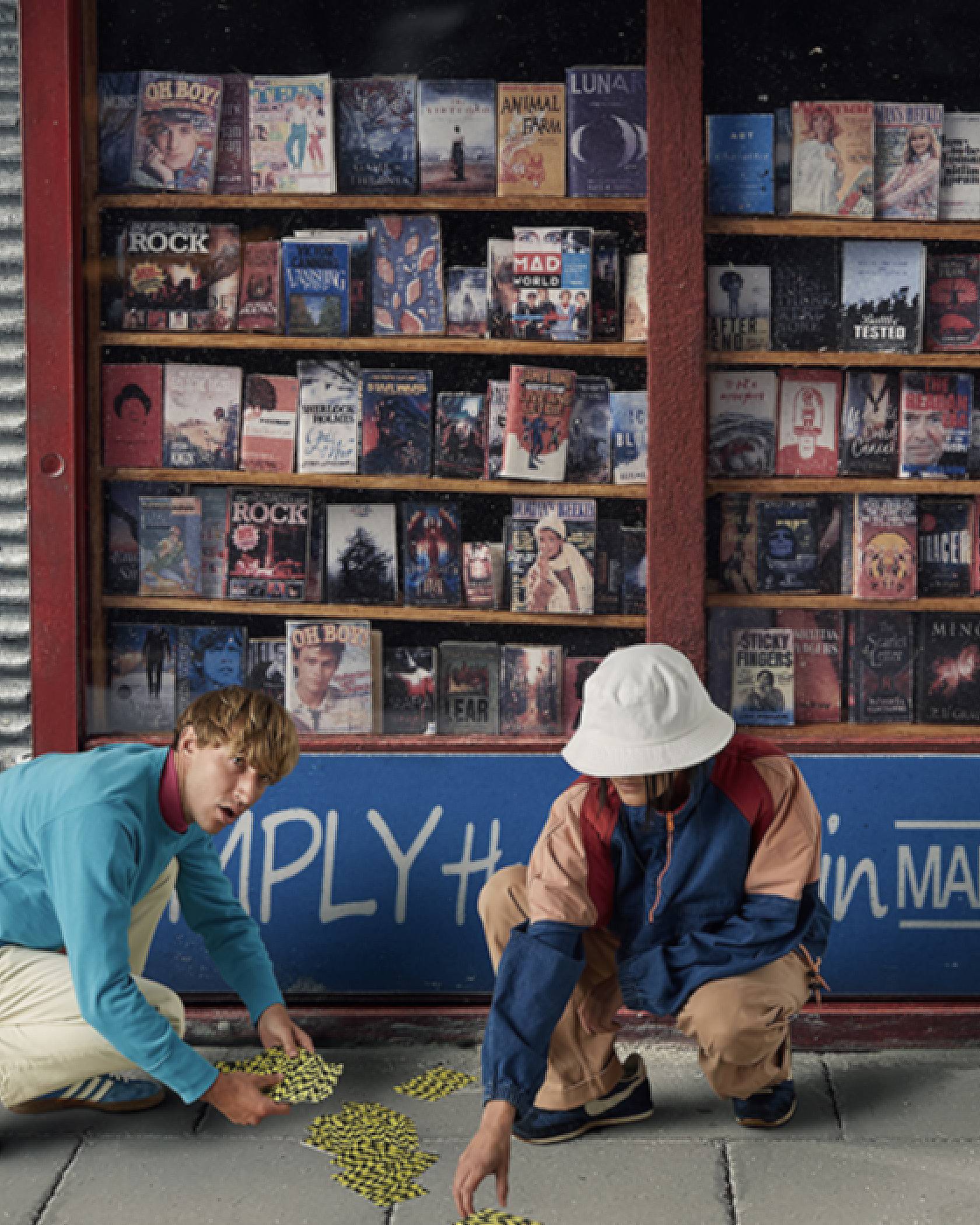 Two men picking up cards on the floor from in front of a record shop