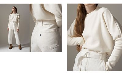 A collage of an image of a woman standing wearing a white top tucked into a pair of white jeans, an up-close image of the back pockets of the jeans she's wearing, and an image of her top and jeans close-up.