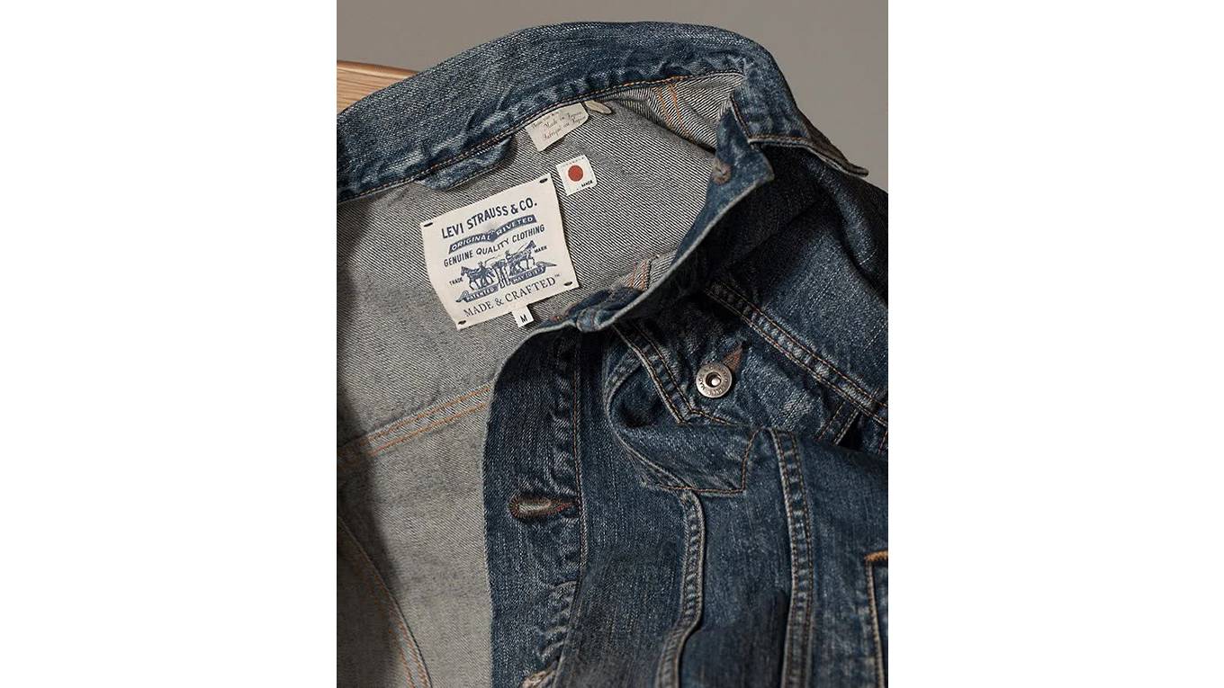 A GIF cycling through an image of a man and woman wearing jean jackets and jeans while sitting down next to each other, an image of a man wearing a jean jacket and jeans standing, an image of Levi's Made and Crafted jean jacket close up, an image of a woman wearing a jean jacket and jeans standing with her legs crossed, and an image of the back pocket of a pair of women's jeans.