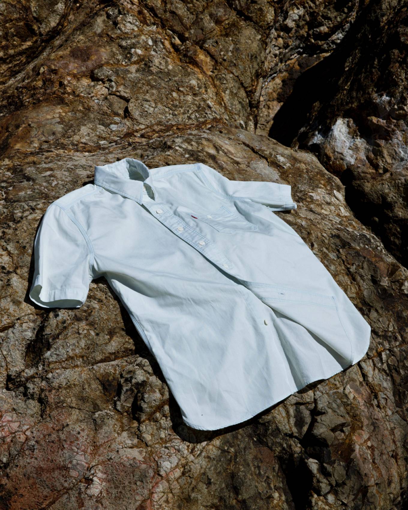 White shirt hanging on a rock.