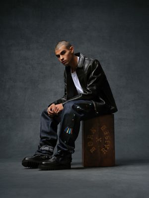 Image of model wearing a black leather jacket, white tee shirt and dark wash denim jeans from the Levi's® & Born x Raised capsule collection.