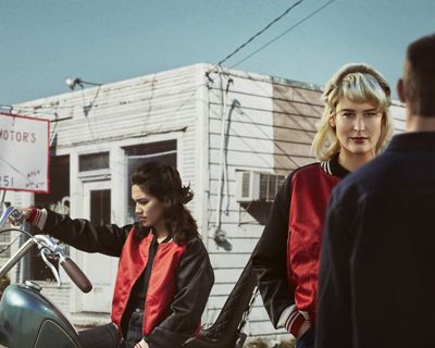 2 women wearing jacket forward