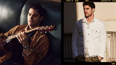 DARREN CRISS sitting on the couch playing guitar.