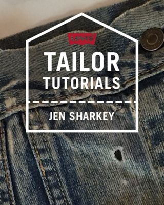 hand fixing hole in denim close up