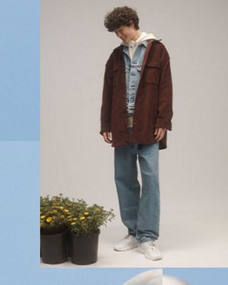 man and woman wearing jeans and long coats