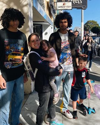 Family standing together on the street in SF.