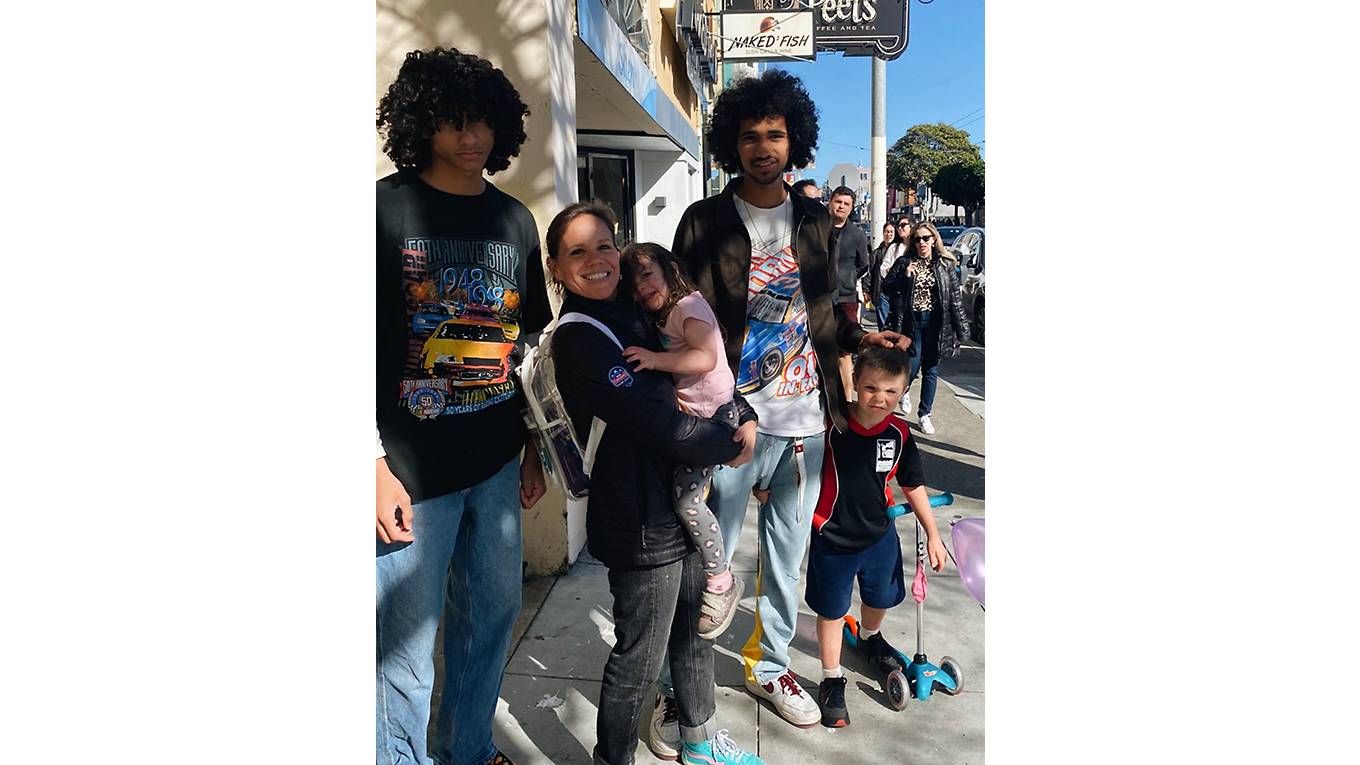 Family standing together on the street in SF.