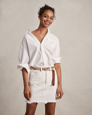 woman wearing white denim skirt and white top