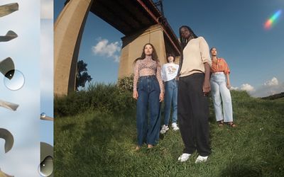 Four models wearing Levi's new sustainable loose jeans standing on a grassy hill