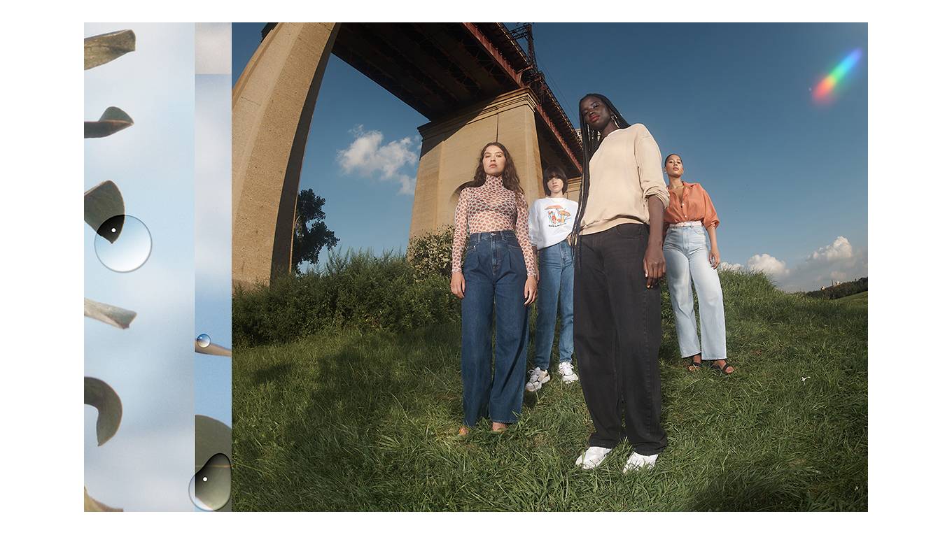 Four models wearing Levi's new sustainable loose jeans standing on a grassy hill