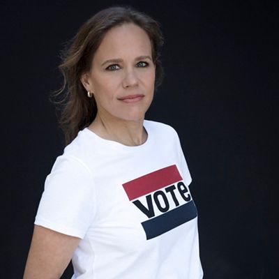 Image of woman wearing a white levi's shirt with a black background.