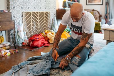 Johnny Wujek working on a denim jacket