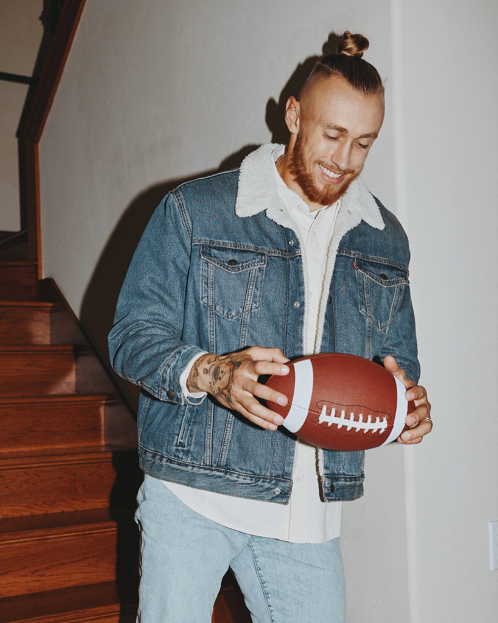 Image of George Kittle holding a football.