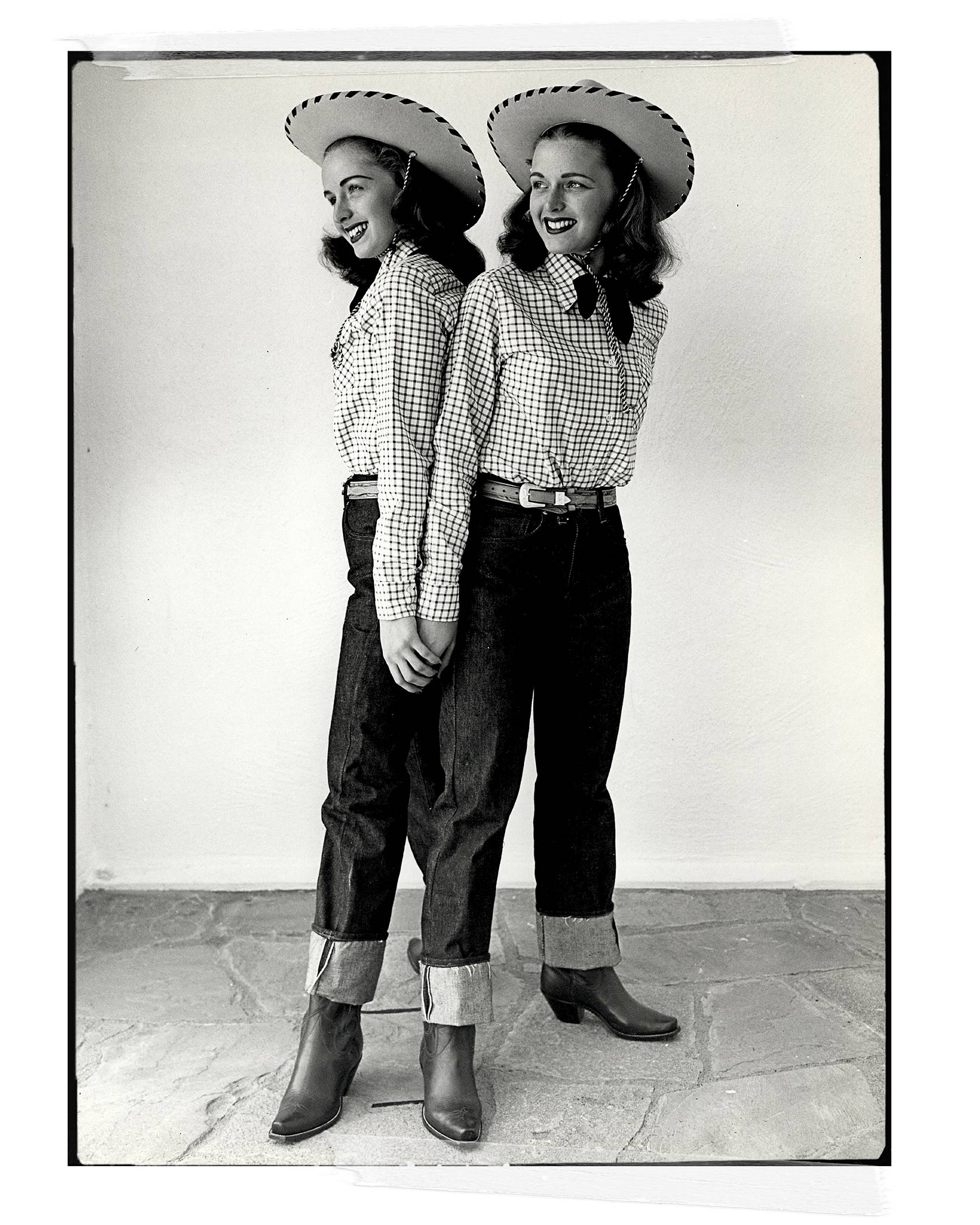 Twins wearing cowboy hats with a checkered shirt and Levi's jeans.