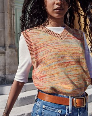 Close up of a woman in a abstract woven patterned vest over a white tee 2022_fall_outfits_for_women