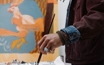 Close-up image of Joonbug's hand as he paints.