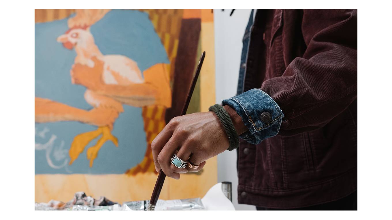 Close-up image of Joonbug's hand as he paints.